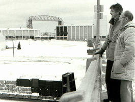 2 men in winter looking at railroad yard