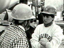 Man, woman in hard hats, talking