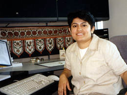 Woman seated in cubicle