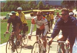 Several men riding bicycles