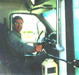 Man sitting in bus driver's seat with open door