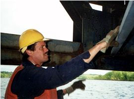 Man inspects under Stillwater Bridge