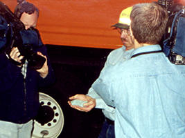 2 cameraman focusing on man holding blue salt