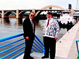 2 men standing by a river port