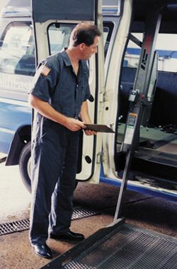 Man at open door of handicapped accessible vehicle