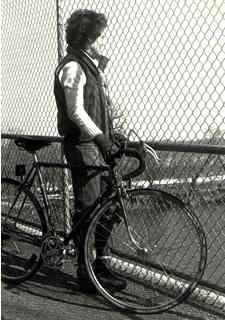 Woman, bike on bridge overpass