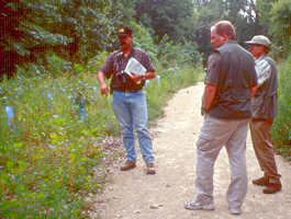 3 people on an outdoor wooded path