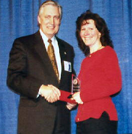 Man presenting Pride Award to woman