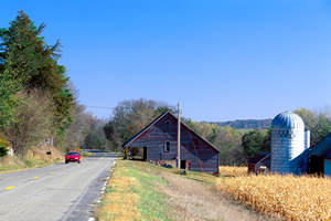 Road running by old barn