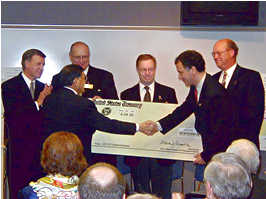 6 men holding oversized check