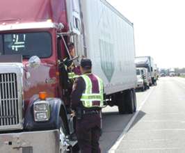 Man inspecting semi