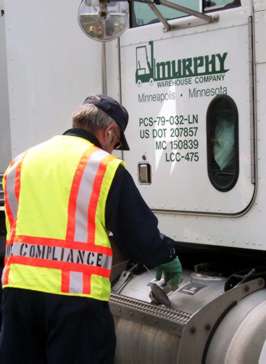 Man inspecting truck fuel tank