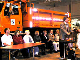 Award ceremony near orange truck