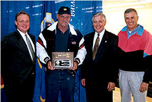 4 men holding award
