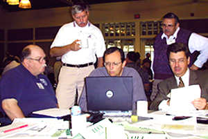 5 men working at computer