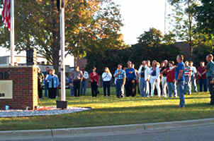 People saluting flag-raising