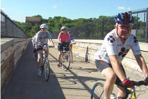 4 bikers on a bridge