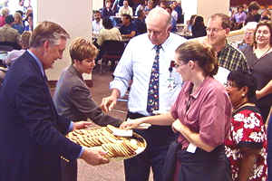 Man serving cookies to crowd