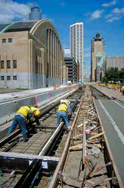 Workers laying light rail track