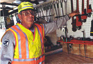 Man pointing at tools on wall