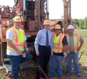 4 men in hard hats at work site