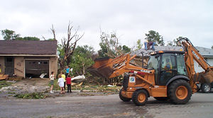 Front loader carrying debris