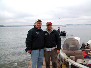 Woman, man on dock next to fishing boat