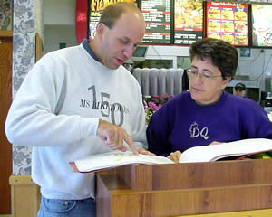Man, woman looking at construction plans