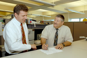 2 men looking at financial spreadsheet 