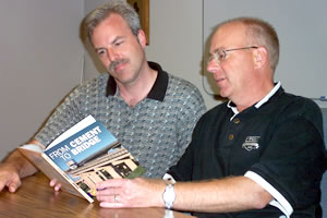 2 men looking at book