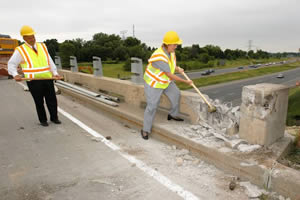 Man, woman with sledgehammers breaking bridge