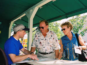 Man providing info to fairgoers