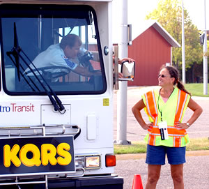 Woman talking to bus driver