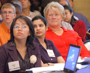 3 women listening to presenter