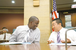 2 men talking at table