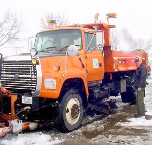Man fueling snowplow