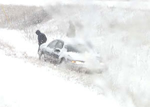 Car in snowy ditch