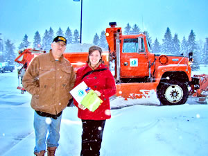 Man, woman next to plow