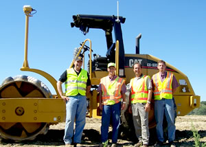 4 men in front of roller