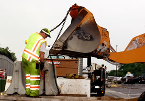 Man cleaning up tanker spill on road