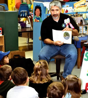 Man reading book to kids