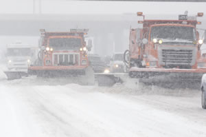 2 snowplows working in tandem