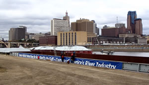 Barge on river with downtown St Paul in background