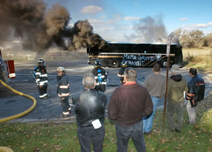 crowd watching live demo of burning bus