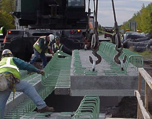 Prefab deck lowered to bridge