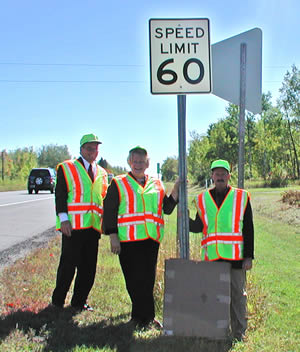 3 people by new speed sign