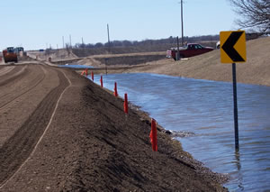 Flood water seeps into road construction site