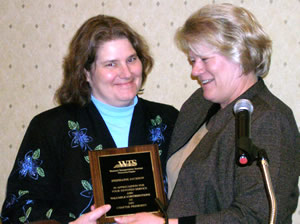 2 women holding award