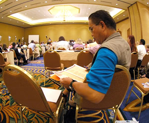 Man reading conference agenda