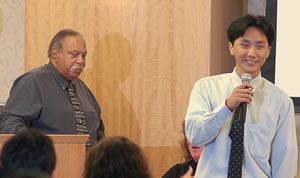 2 men speaking at conference